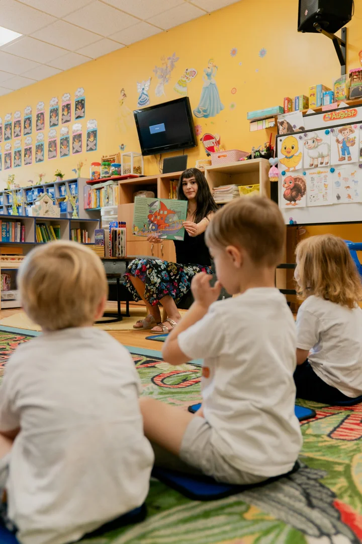 teacher reading a dual language storybook to preschool children teacher reading a dual language storybook to preschool children