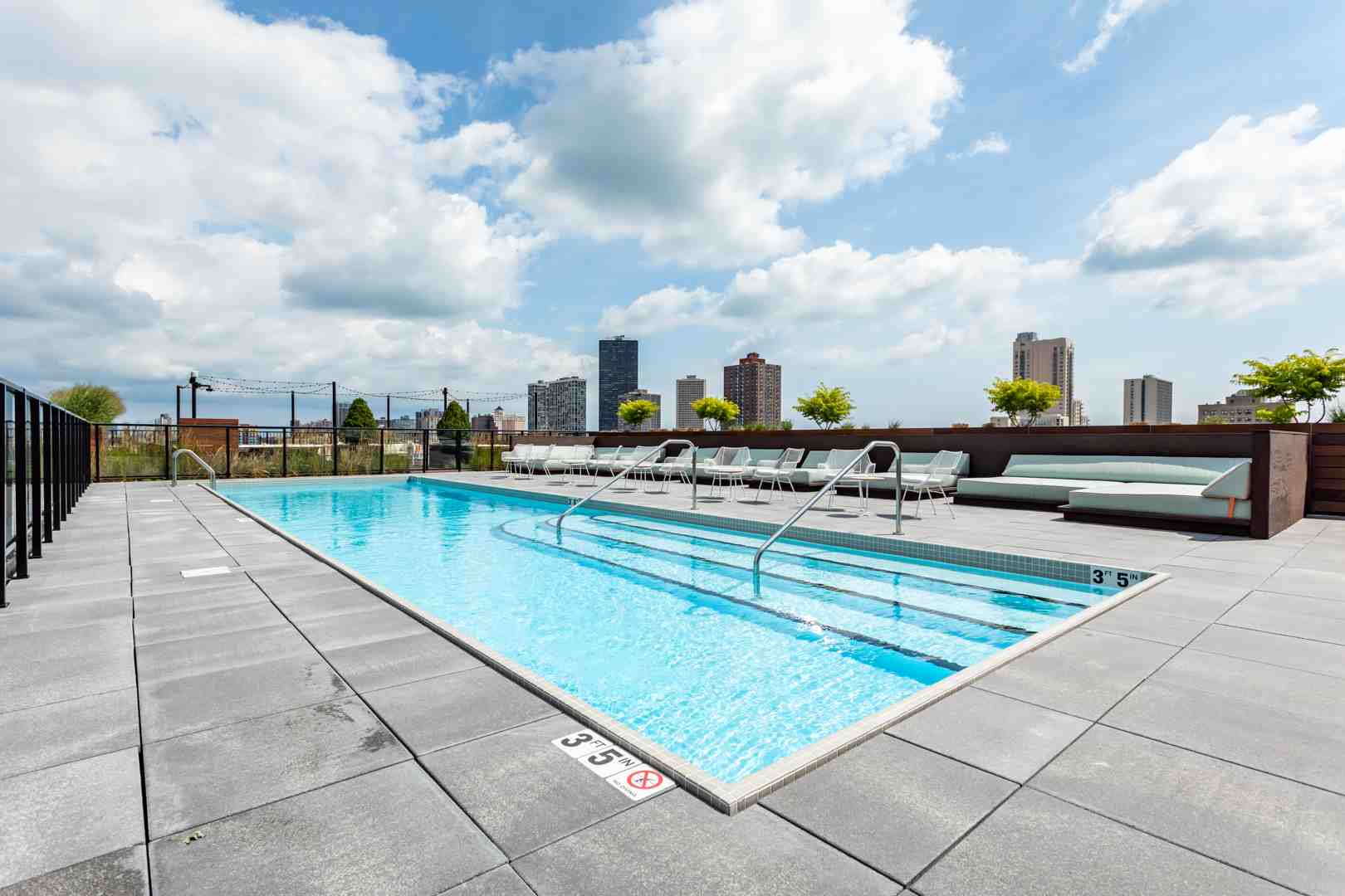 Rooftop pool at sunset with Chicago skyline views - Luxury studio apartments Chicago