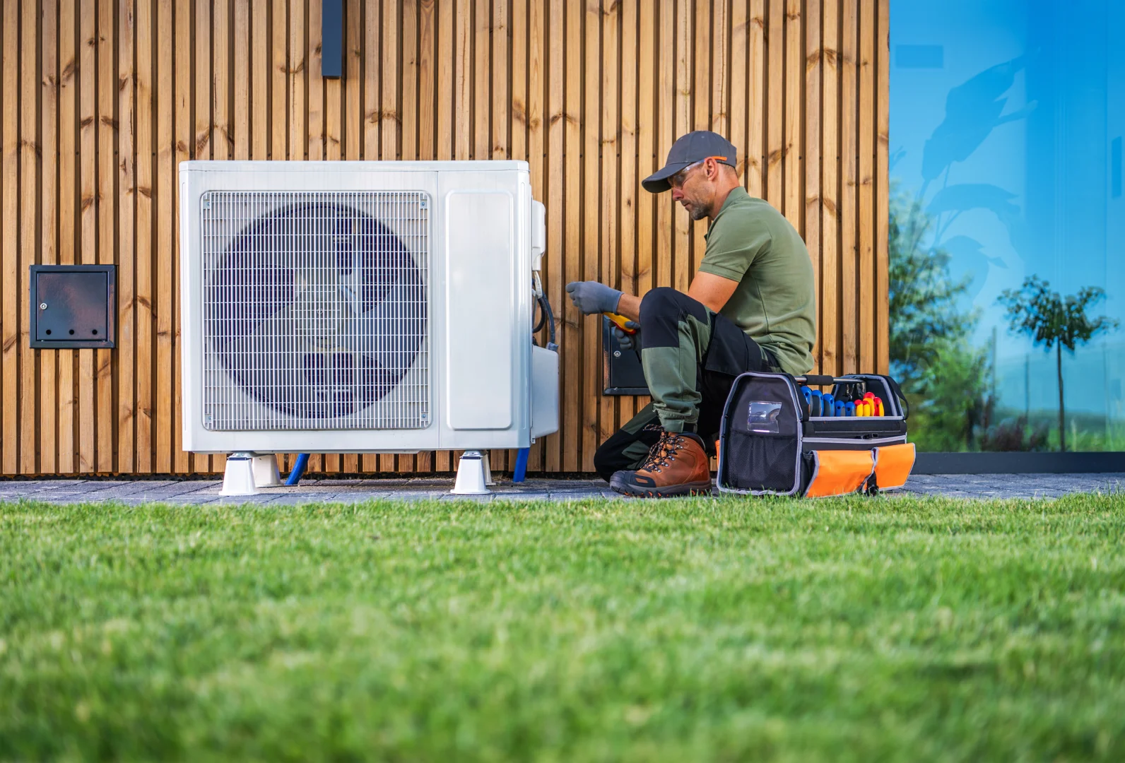 Modern air conditioning unit installed outside a Birmingham home Modern air conditioning unit installed outside a Birmingham home
