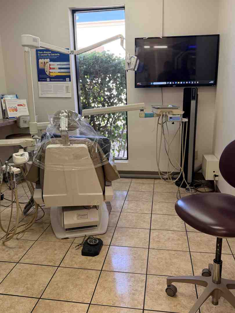 Modern dental treatment room featuring comfortable seating and ceiling mounted TV screens Modern dental treatment room featuring comfortable seating and ceiling mounted TV screens