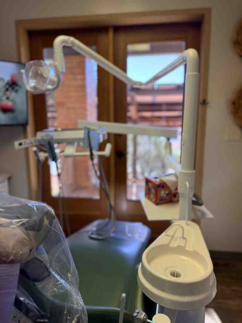A dentist performing a thorough oral examination to check for tongue indentations and jaw alignment