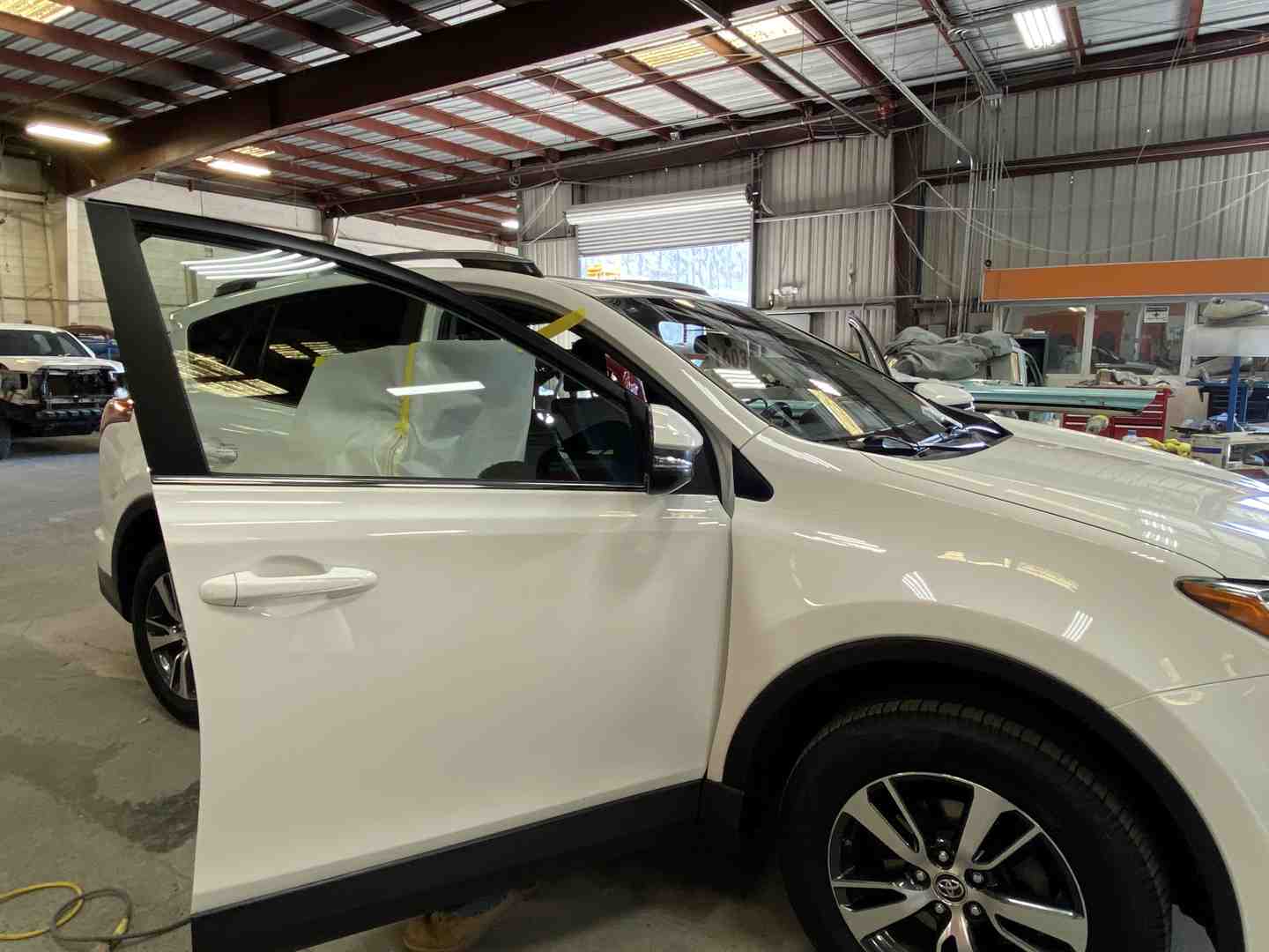 Rainbow Auto Center's clean, professional auto body shop bay - tesla dent repair near me