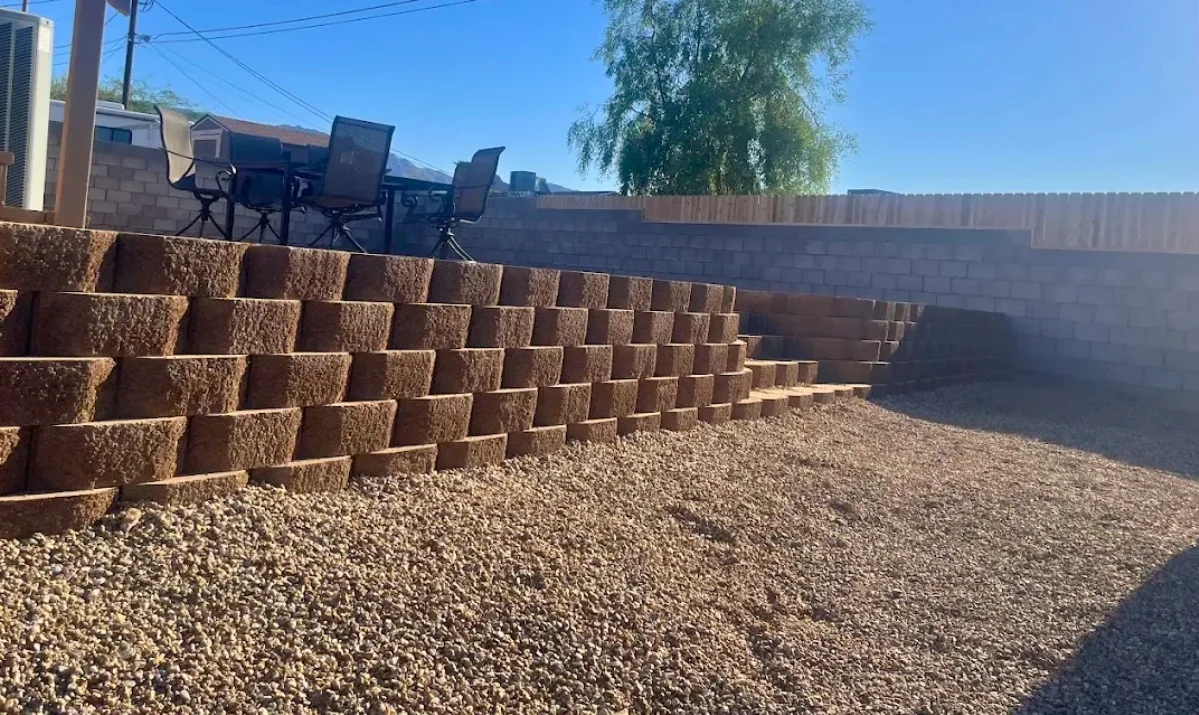 Completed tiered retaining wall project in an Arizona desert landscape with pavers and desert planting