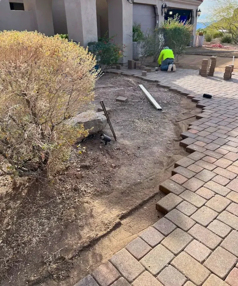 Professional paver installation showing proper sub-base compaction and edge restraint