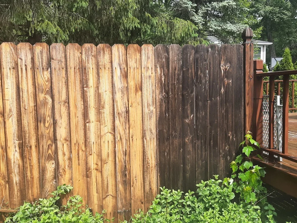 clean commercial wood fence showing professional pressure washing results