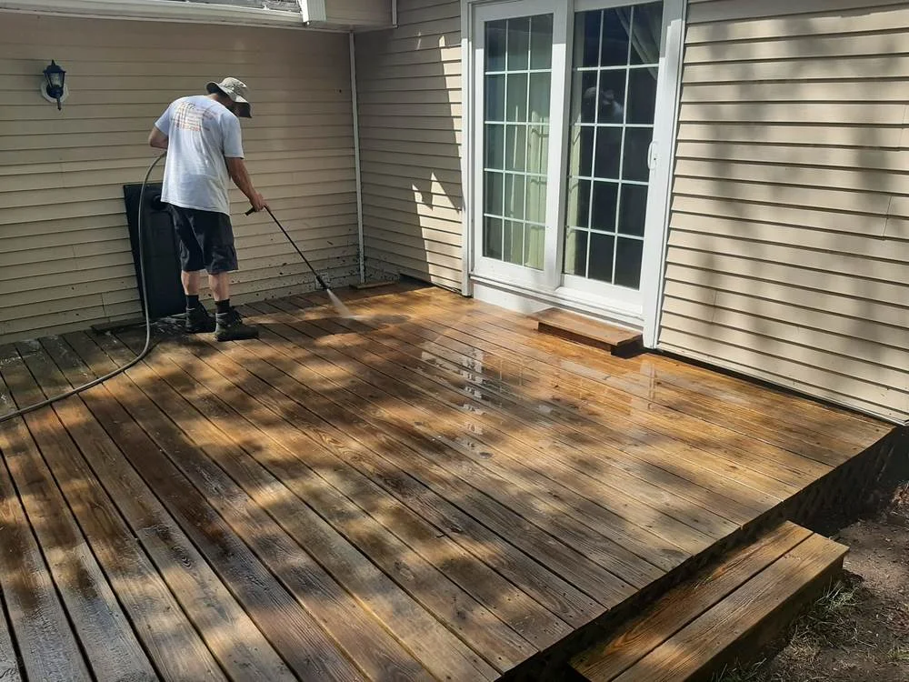 Professional soft washing equipment cleaning a wooden deck surface - eco deck restoration Merrimack