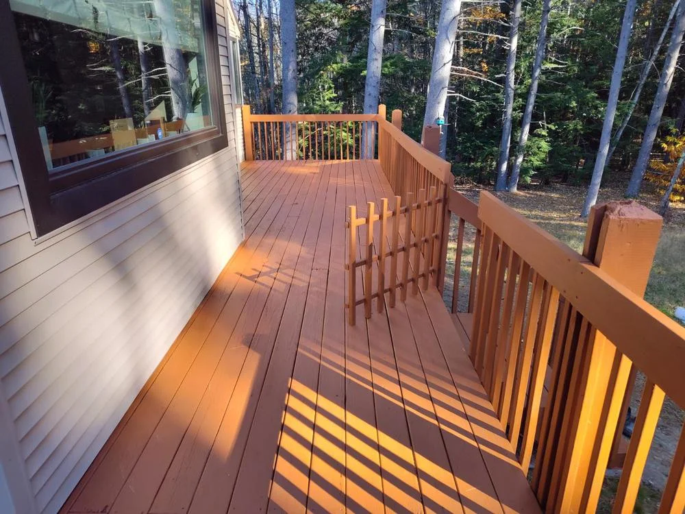 A beautifully restored New Hampshire wood deck looking rich, clean, and fully protected