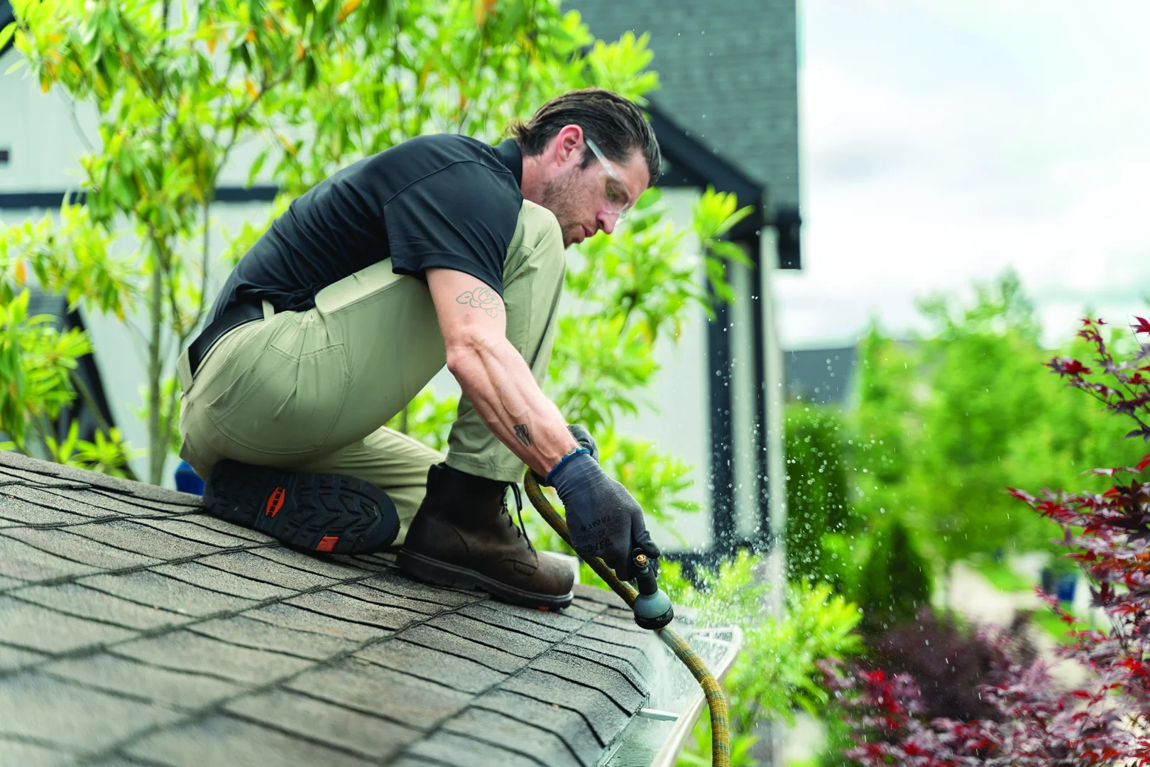 Professional technician performing a gutter inspection on a Middle Tennessee home