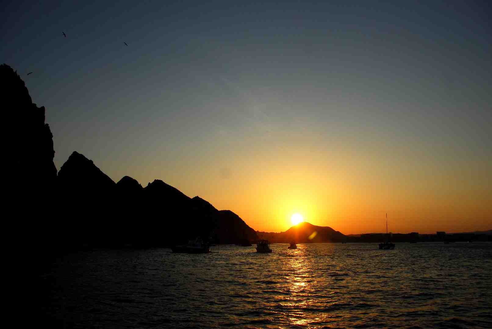 sunset over playa medano with golden light - things to do in cabo