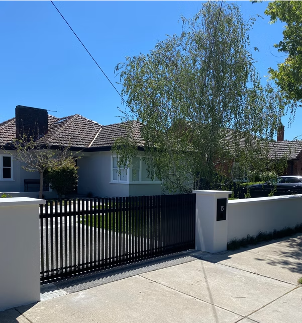 Automated artistic metal driveway gate