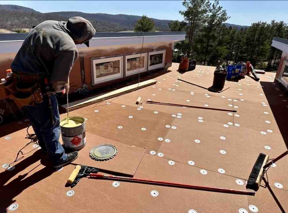 Flat roof maintenance checklist being reviewed by roofing professional - flat roofing materials