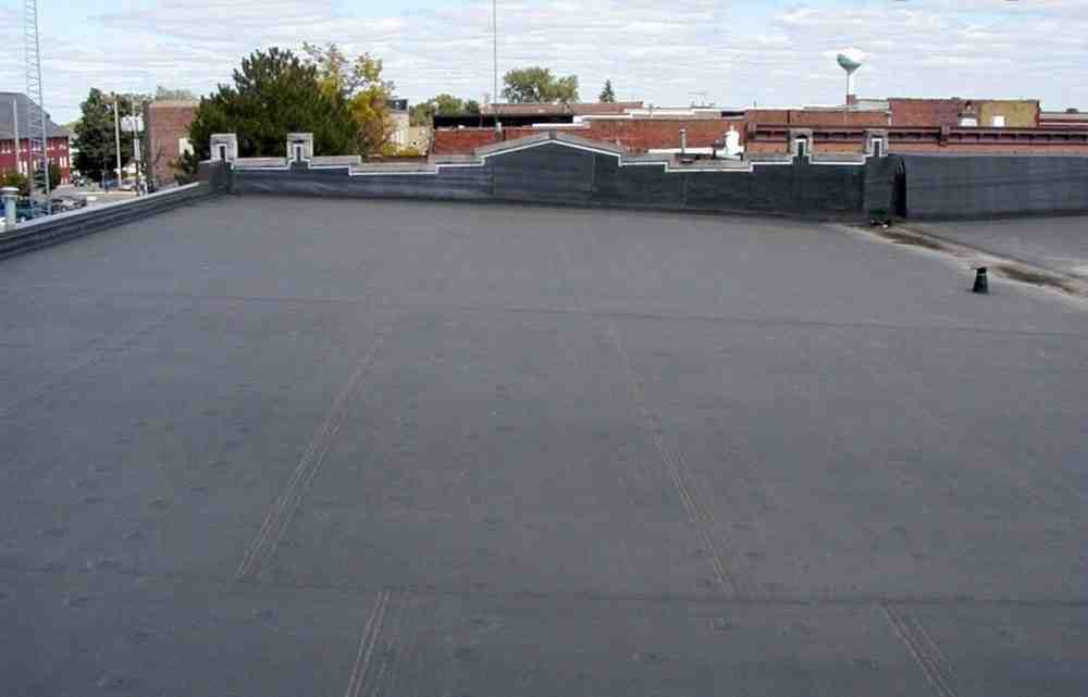 TPO flat roof installation showing white reflective surface - high quality flat roofing