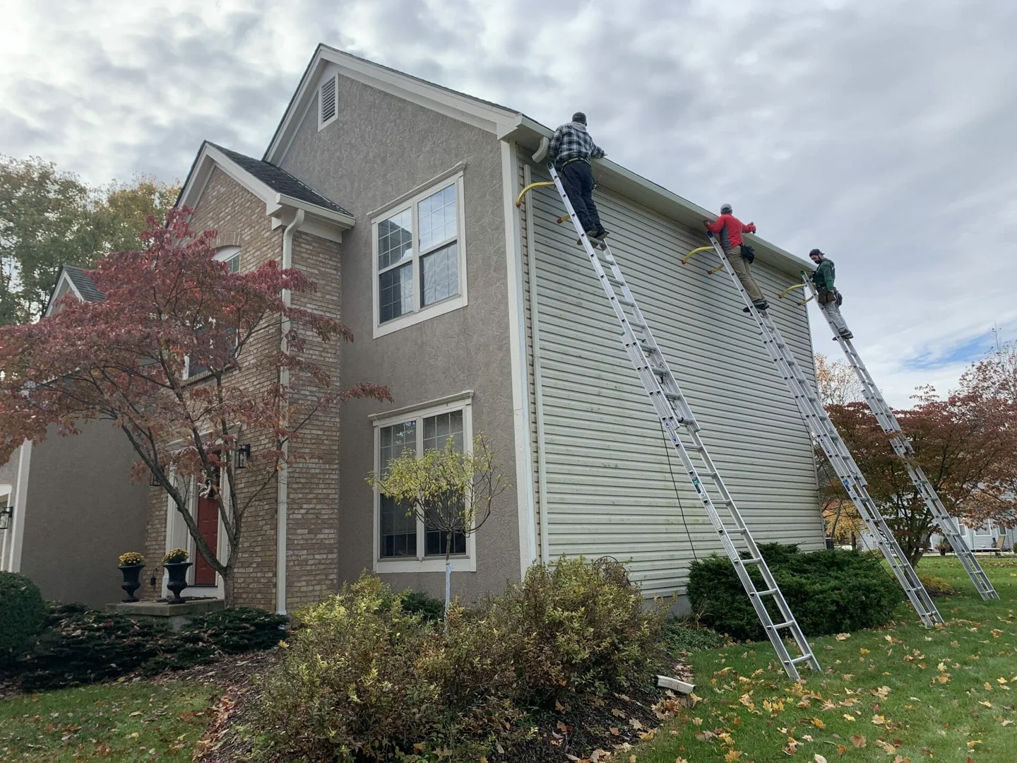 Professional installer measuring gutters for a custom-fit system