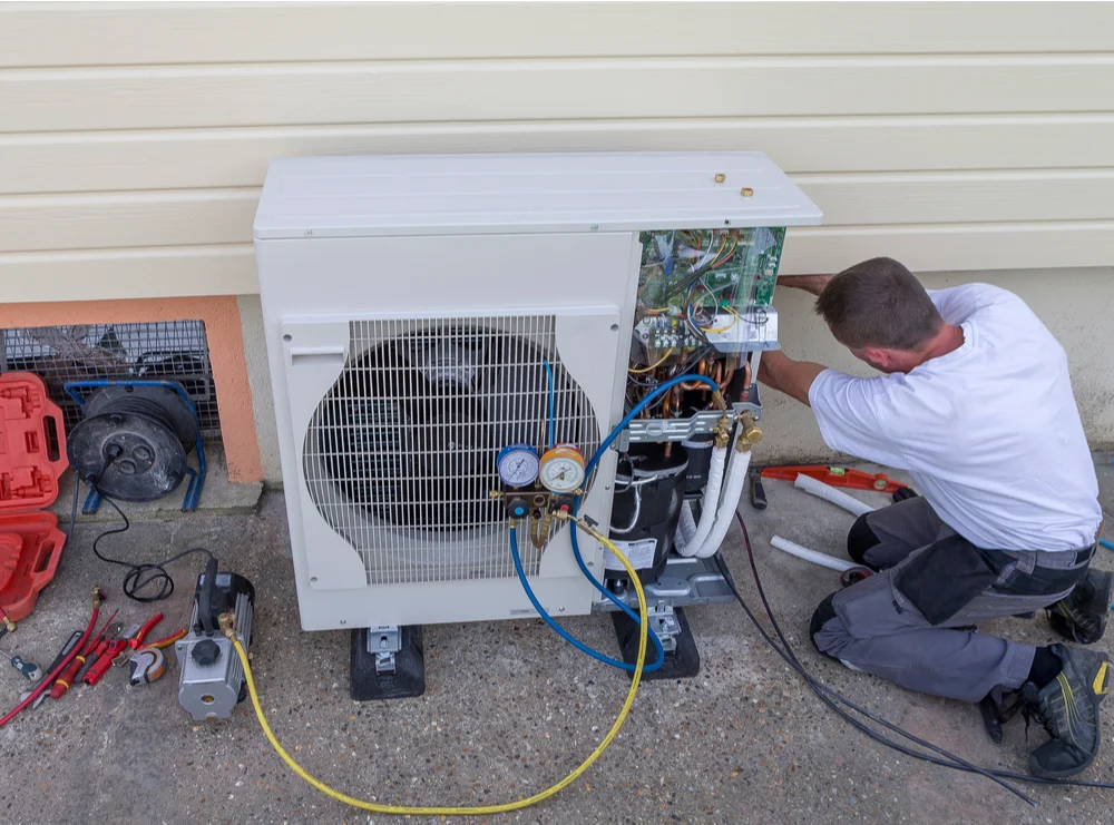 HVAC specialist conducting seasonal heat pump maintenance HVAC specialist conducting seasonal heat pump maintenance