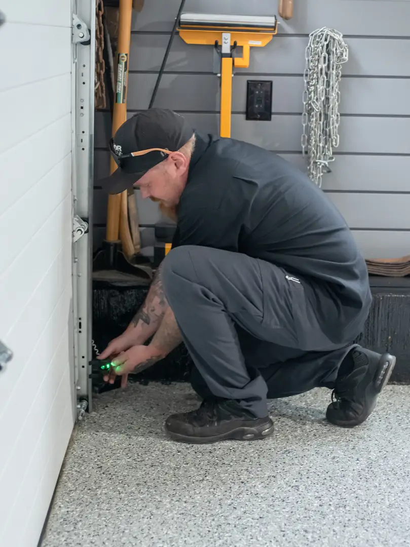 technician inspecting garage door system