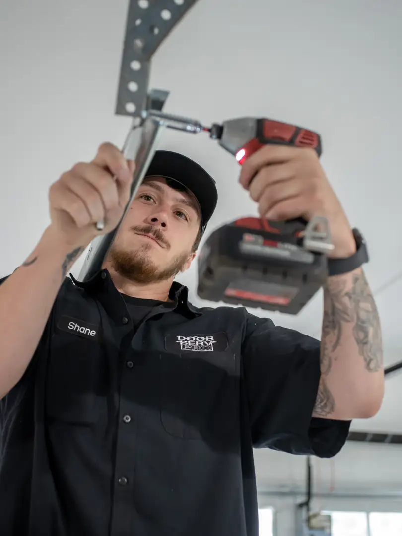 certified technician installing a garage door