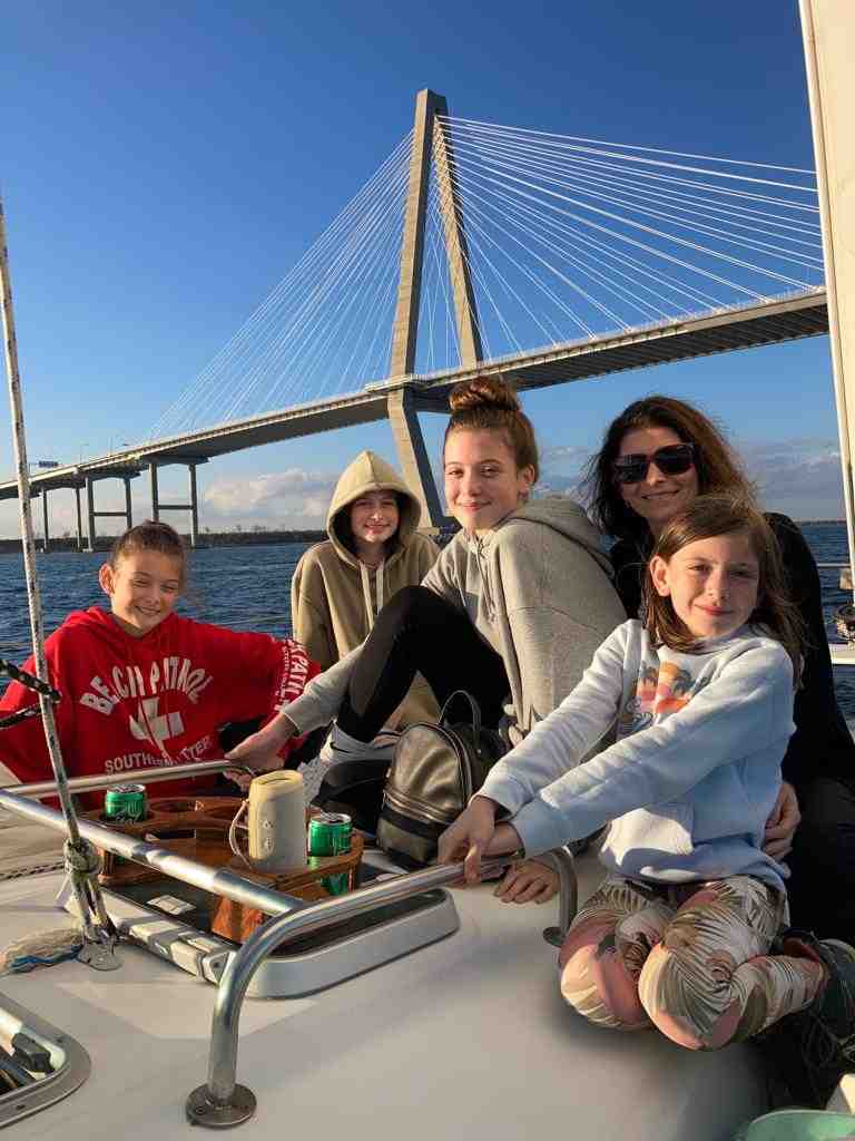 family enjoying private sailboat charter in Charleston - what are the 3 types of charter