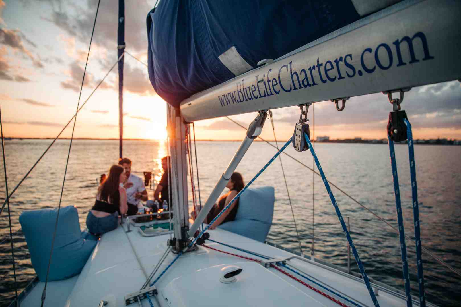 beautiful sunset over the water from a yacht in Charleston - what are the 3 types of charter