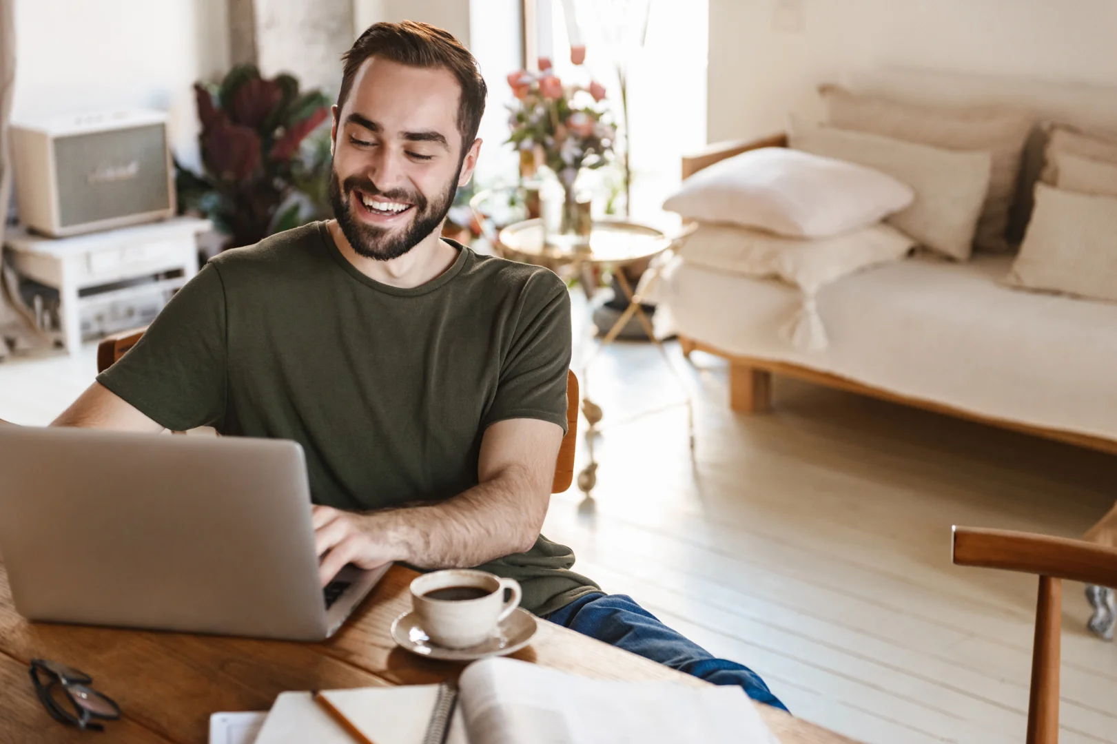 a man chatting on his computer happily indoor-burnout prevention daily habits a man chatting on his computer happily indoor-burnout prevention daily habits