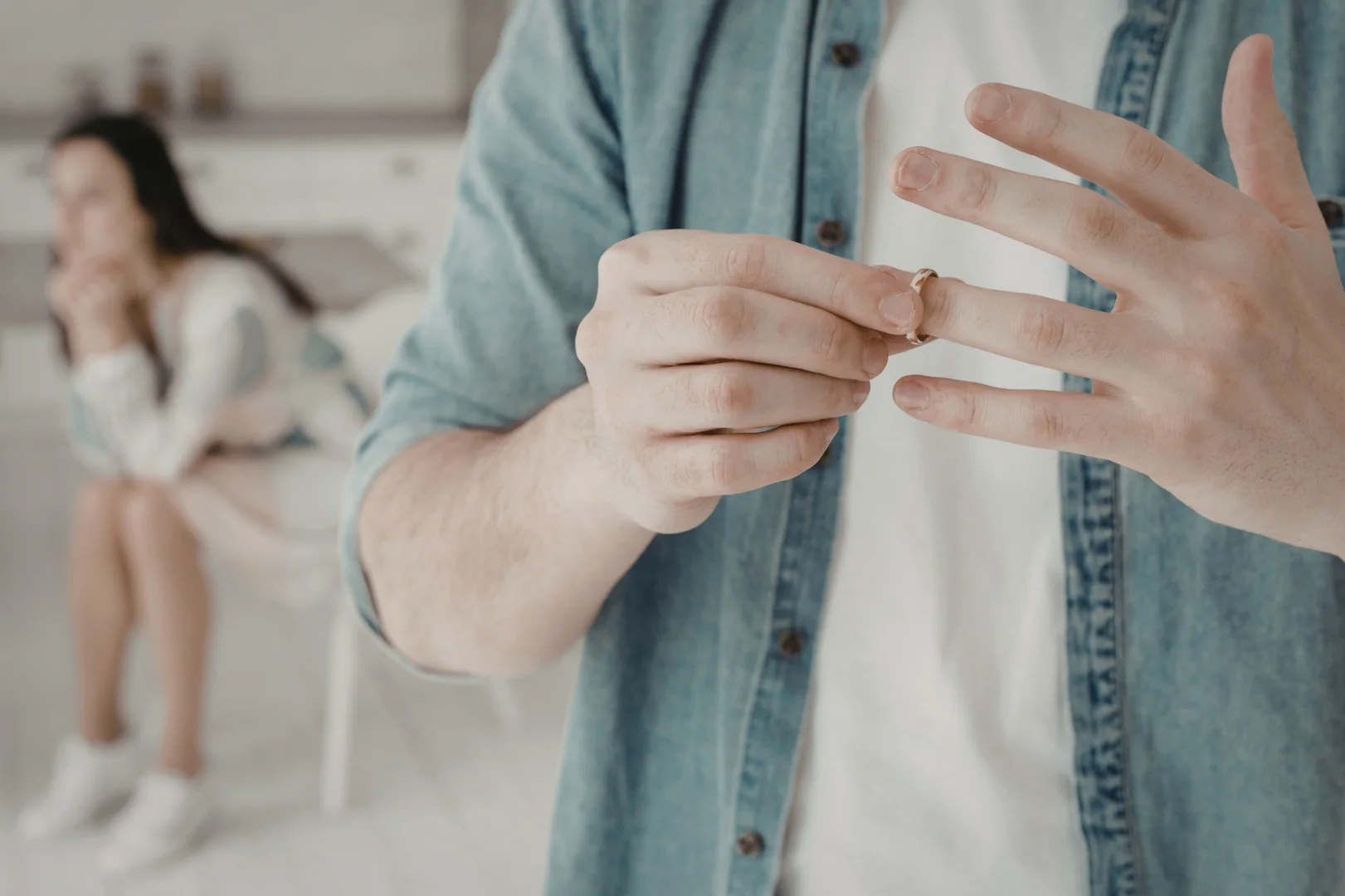 close up of a man considering taking off his wedding band - therapy infidelity