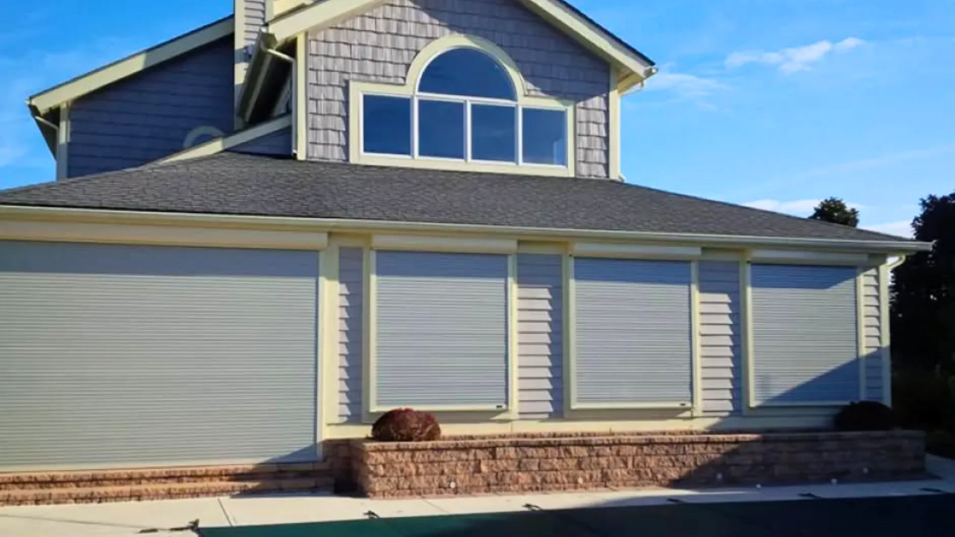 Professional installer mounting a custom retractable awning frame