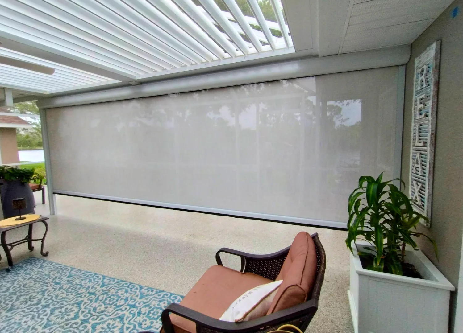 Aluminum pergola defining a residential outdoor living area