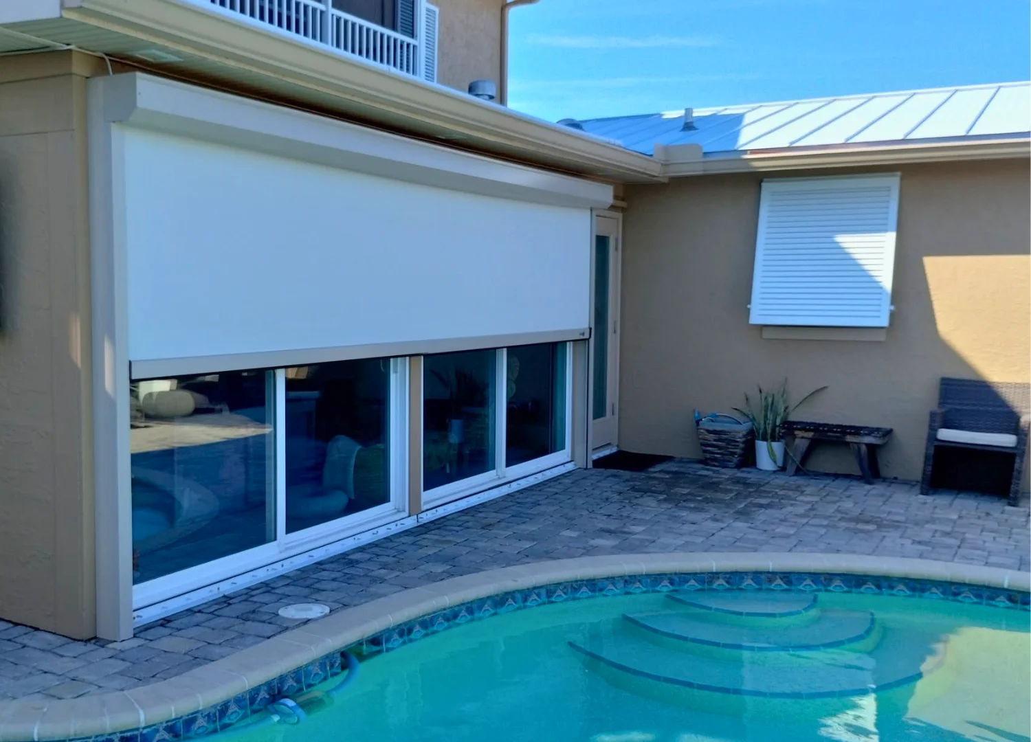Exterior hurricane screen covering a wide patio opening Exterior hurricane screen covering a wide patio opening