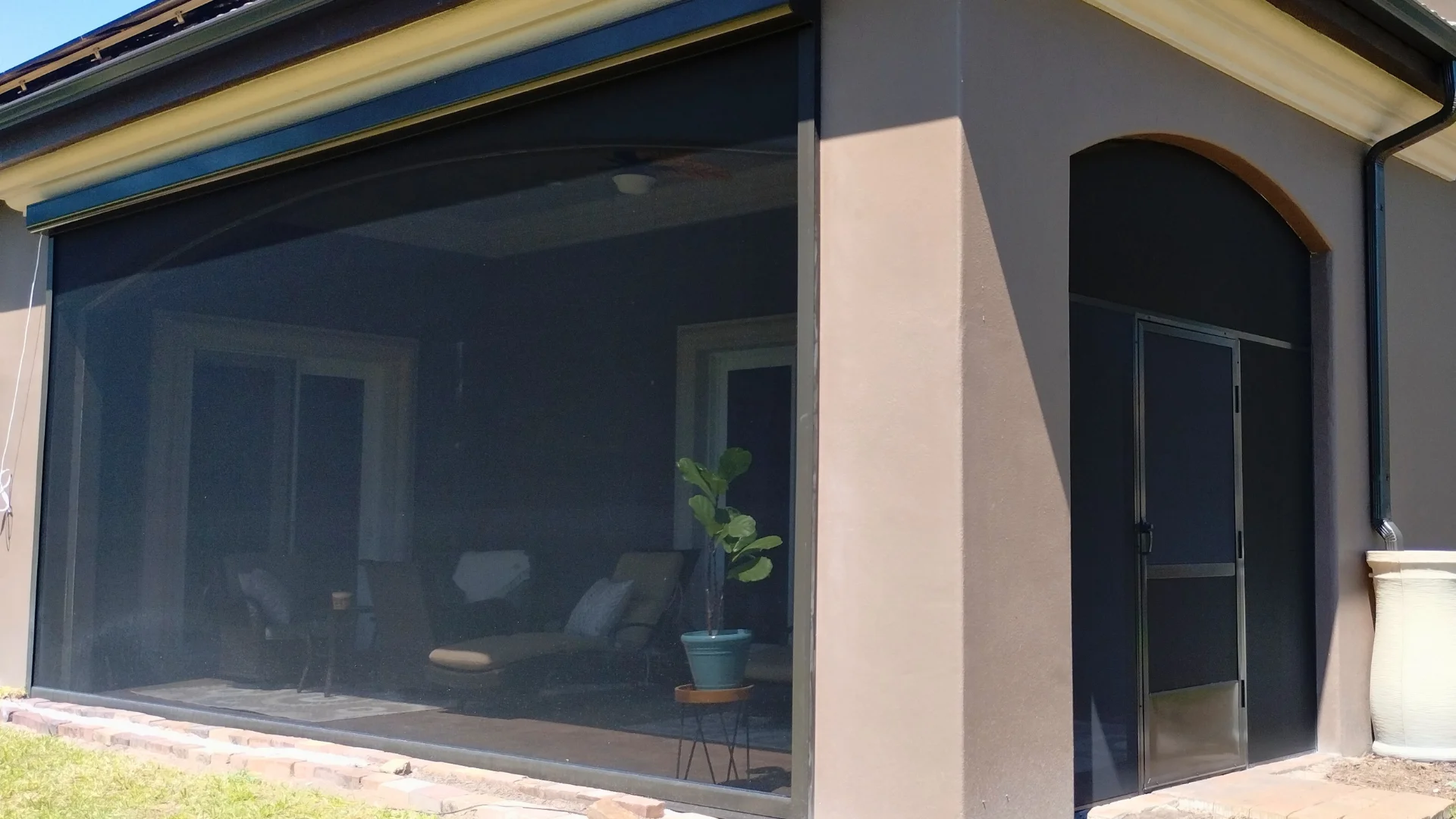 Exterior screen installation at a residential outdoor opening