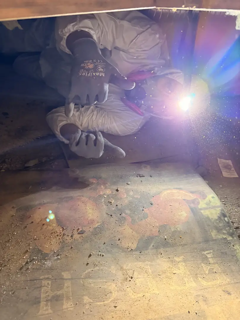 Professional technician inspecting attic insulation and sealing air leaks - summer energy saving tips for san diego