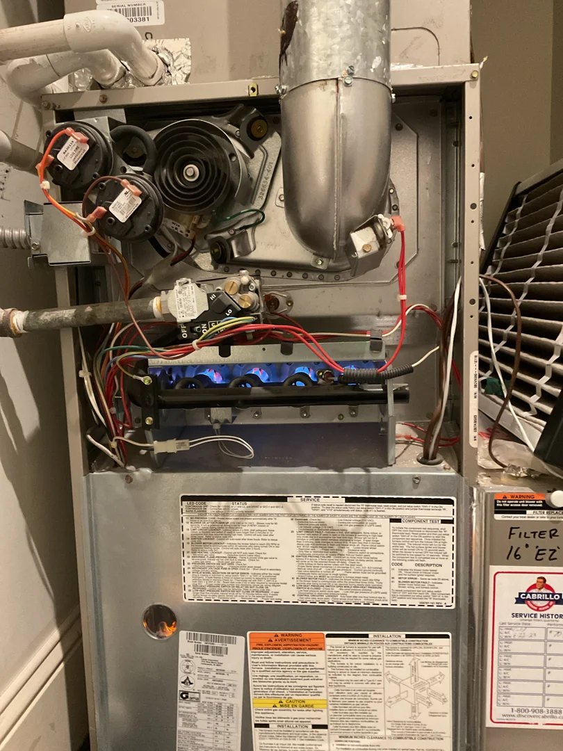 technician inspecting a residential furnace system technician inspecting a residential furnace system