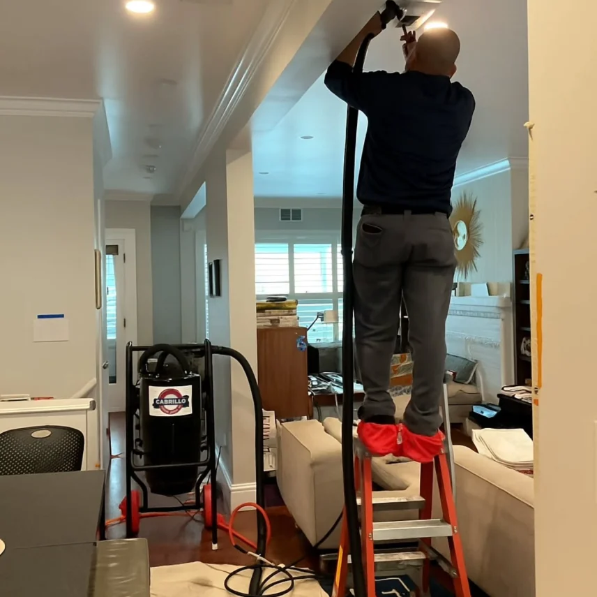technician installing a ductless mini split indoor unit technician installing a ductless mini split indoor unit