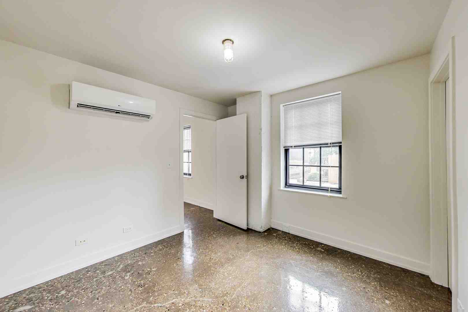 a modern apartment with floor-to-ceiling windows overlooking the city - apartment complexes in chicago il
