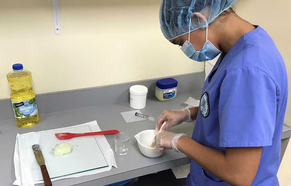 Pharmacy tech student training in lab
