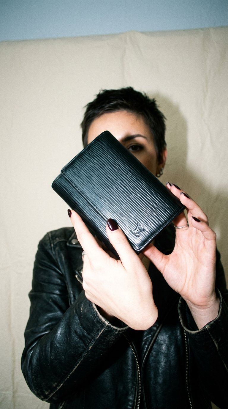 AI product shot of black Louis Vuitton epi bifold