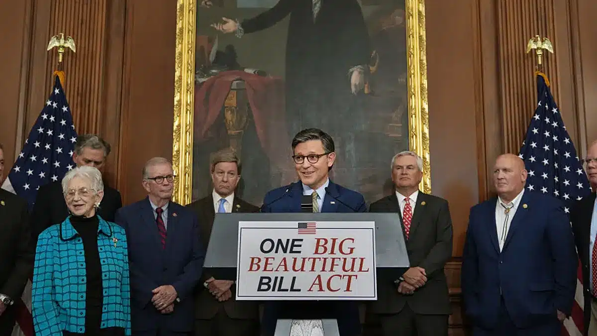 Evento con cartel 'ONE BIG BEAUTIFUL BILL ACT' y banderas