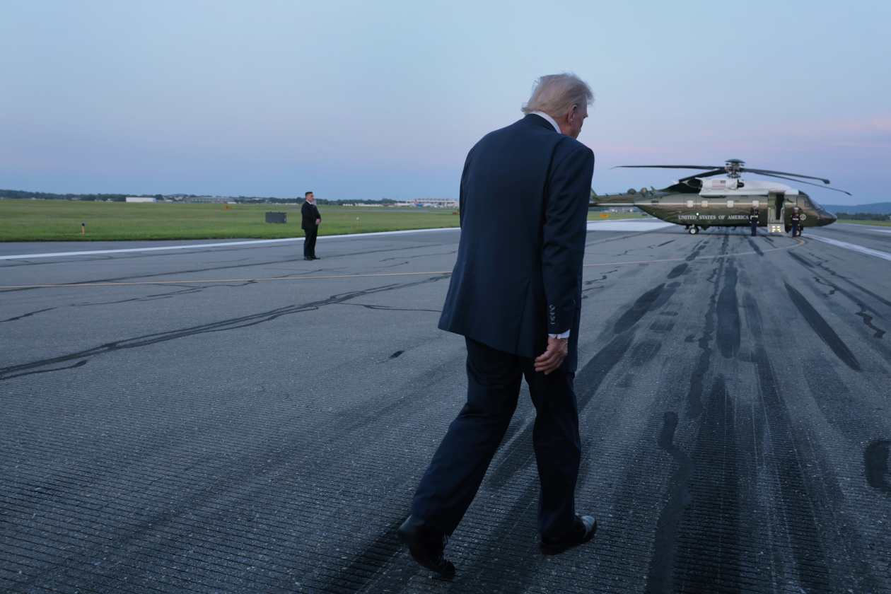 Donald Trump caminando hacia helic&oacute;ptero al atardecer