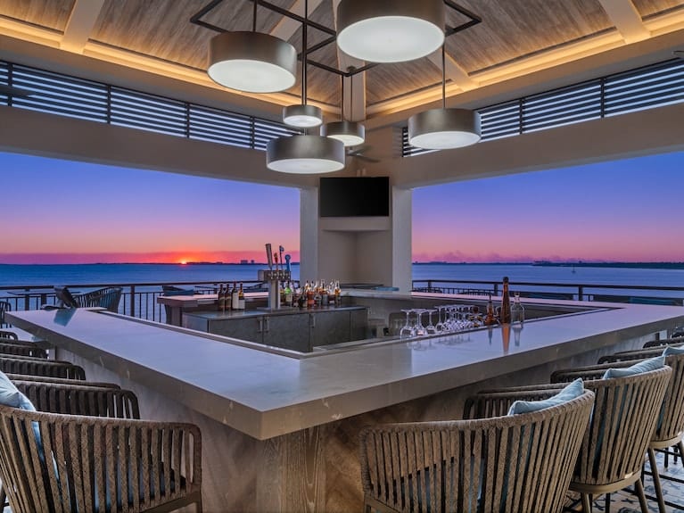 Interior elegante de restaurante con vista al mar al atardecer