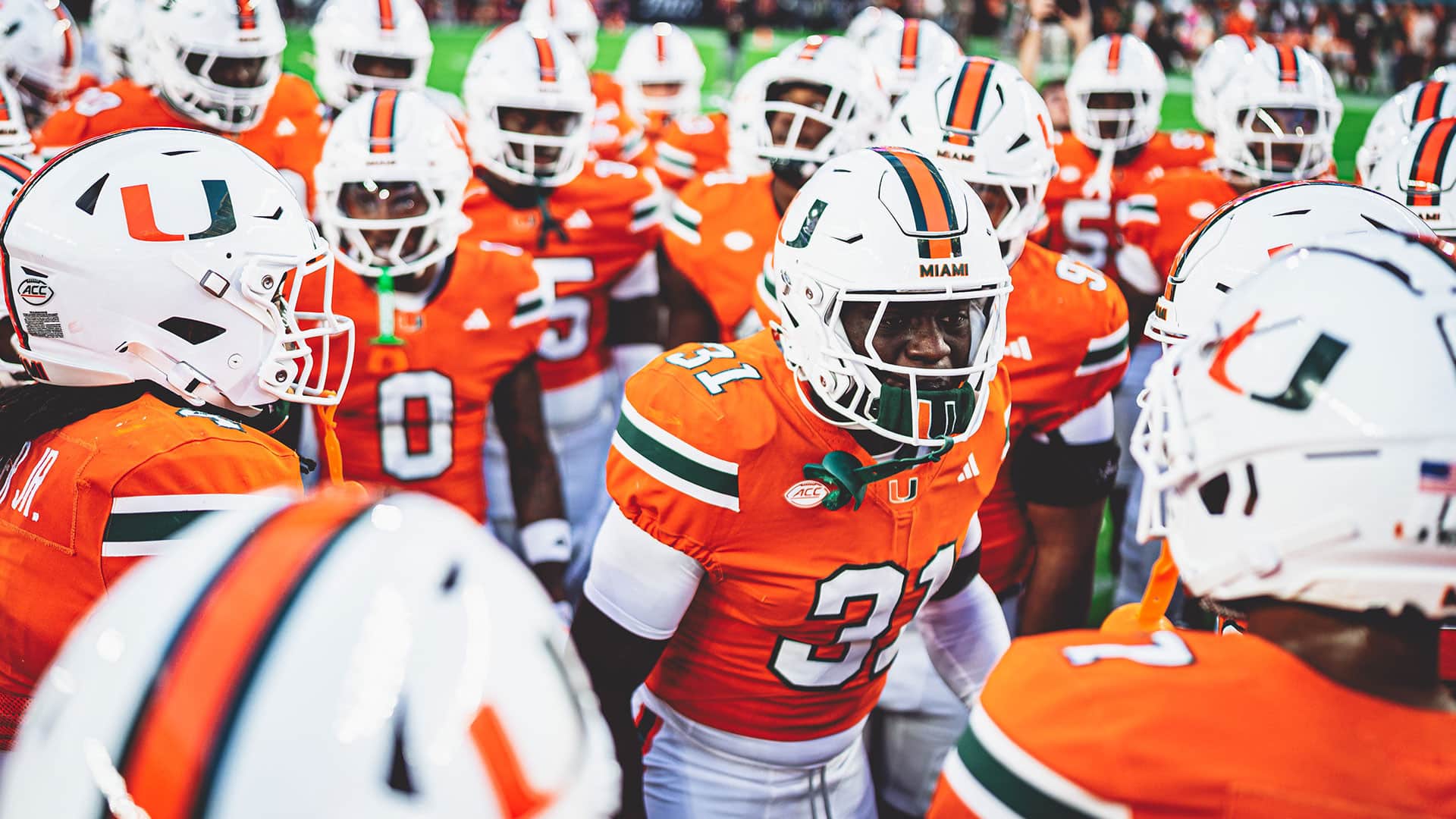 Jugadores de Miami Hurricanes en un huddle previo al partido
