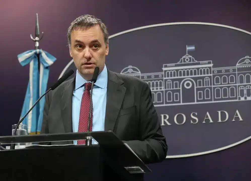 Funcionario en conferencia de prensa con fondo de la Casa Rosada
