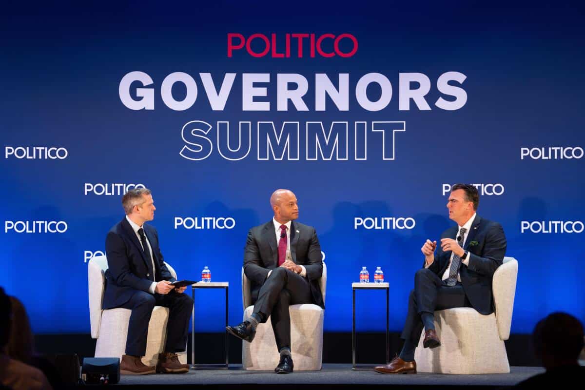 Escenario de Governors Summit con tres hombres en discusi&oacute;n pol&iacute;tica