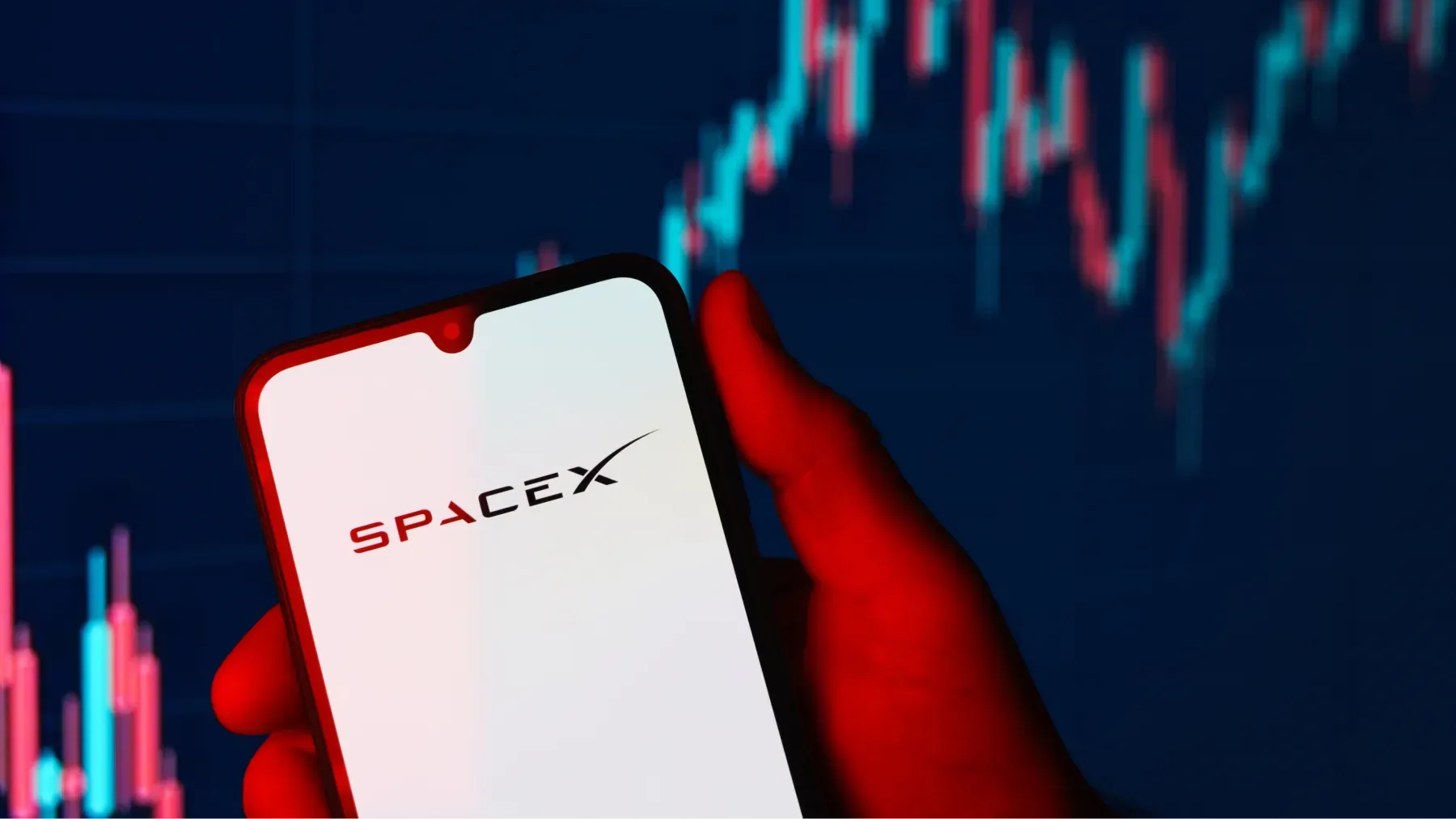 Teléfono mostrando logotipo de SpaceX y gráfico de acciones
