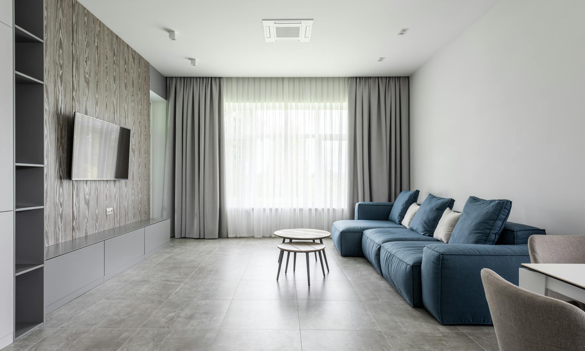 Spacious modern lounge with sofa, soft daylight, and clean styling