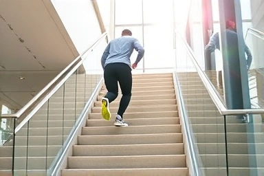 Person climbing stairs, burning calories, healthy exercise