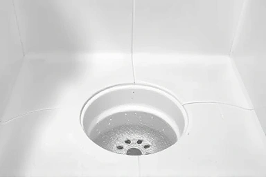 Symbol of clean grout lines and drain after cleaning