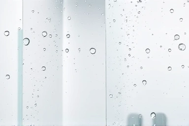 Sparkling clean shower enclosure, water droplets on glass