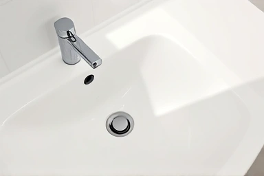 Clean bathroom sink, clear drainage, symbol of solved problem