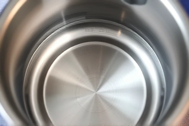 Immaculate interior of a stainless steel electric kettle.