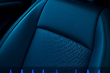 Car seat with cool blue light, symbolizing ventilation and comfort.