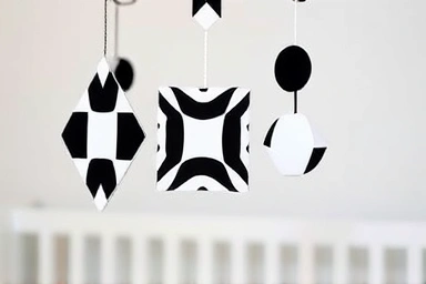 Close-up of a black and white patterned mobile for baby visual development.