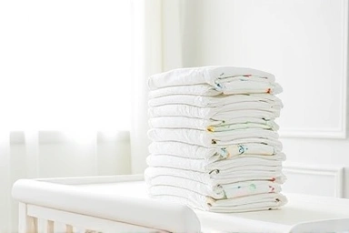 Newborn diapers arranged for comparison and selection.
